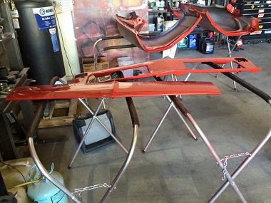 auto body panels painted red and ready for installation